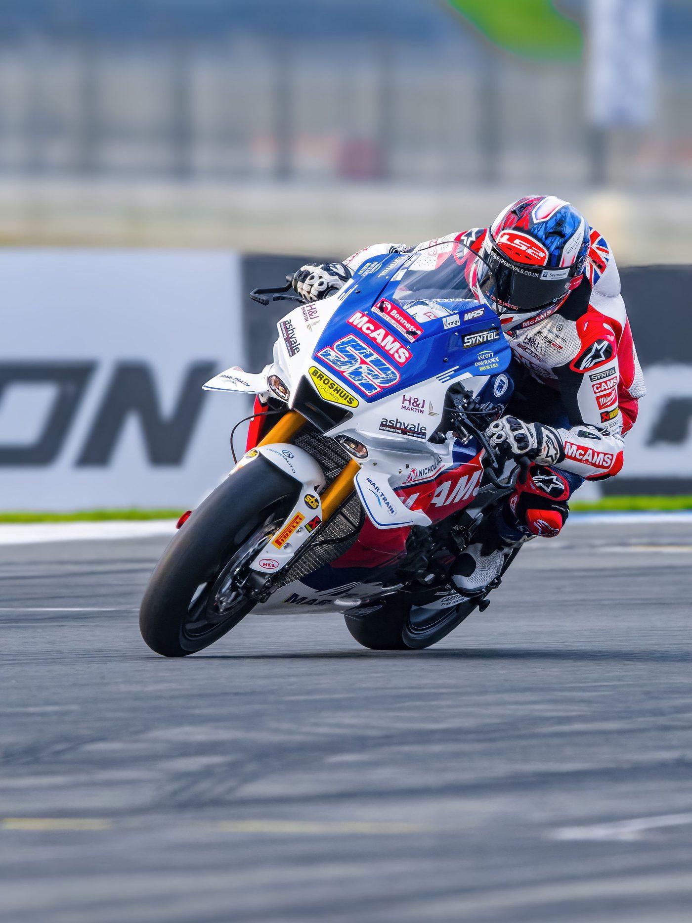 Superbike race photo: rider on the blue and white No. 52 superbike, cornering