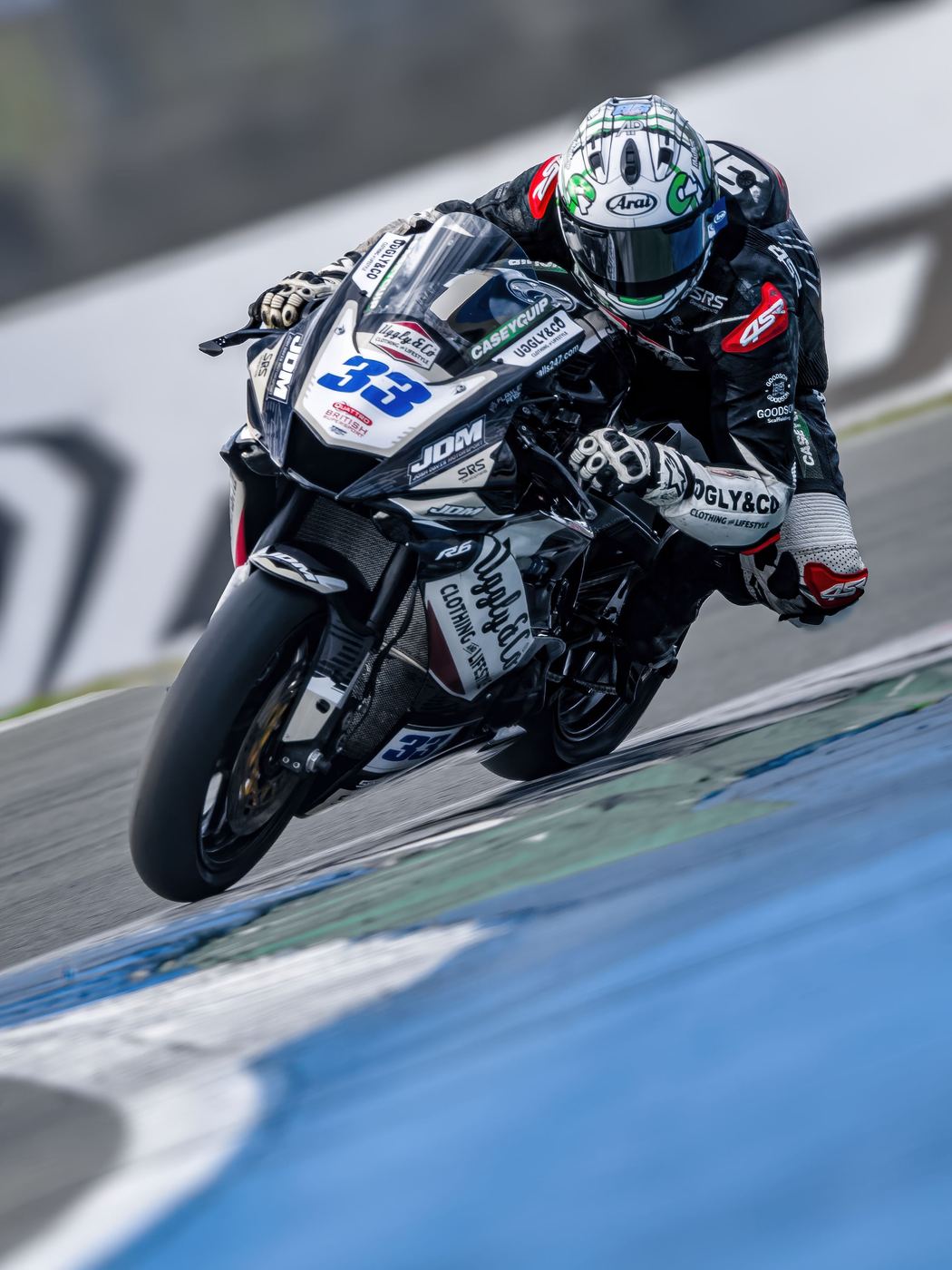 Superbike race photo: rider on the black No. 33 superbike, cornering