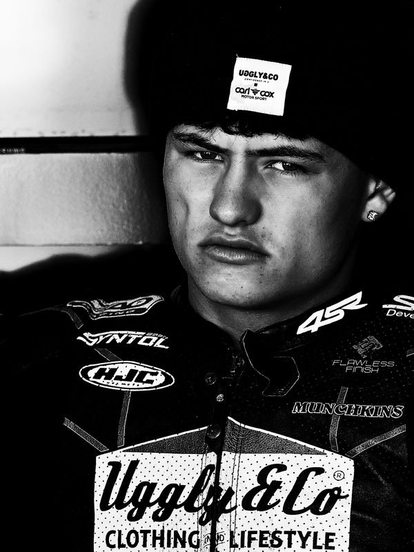 Paddock portrait: black and white image of Carter Brown in an Uggly & Co beanie and team shirt, Cadwell Park 2025