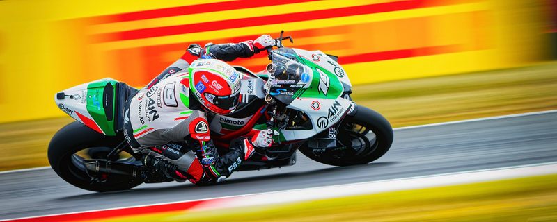 Superbike racing: Joe Talbot on the No. 19 AJN Steelstock bimota, panned against yellow and red streaks, 2026
