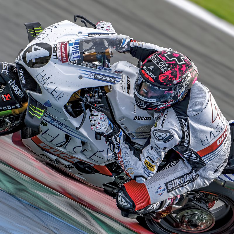 Superbike racing: Scott Redding at full lean on the white Hager PBM Ducati, Assen 2025