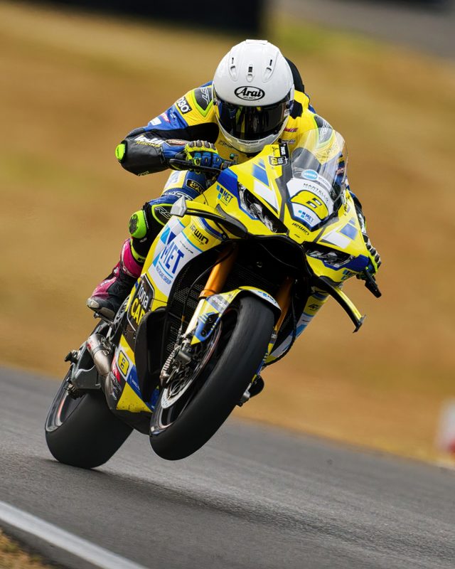 Superbike racing: Graeme Irwin lifts the front wheel of the yellow No. 8 Ducati, Brands Hatch 2026