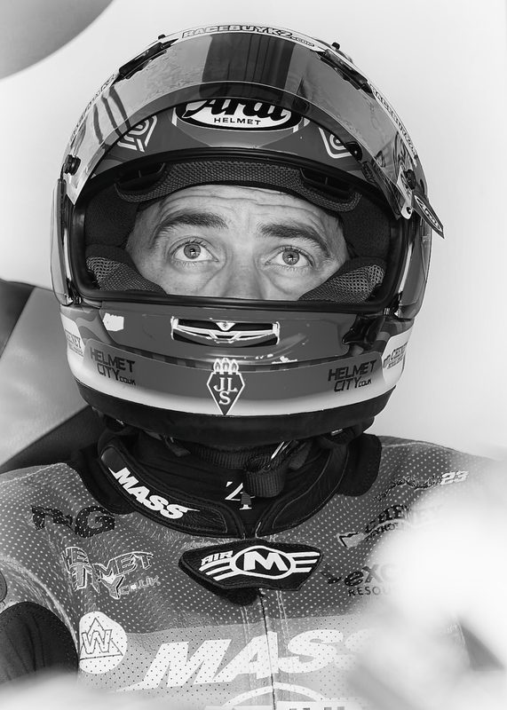 Paddock portrait: black and white image of Luke Hedger in his helmet